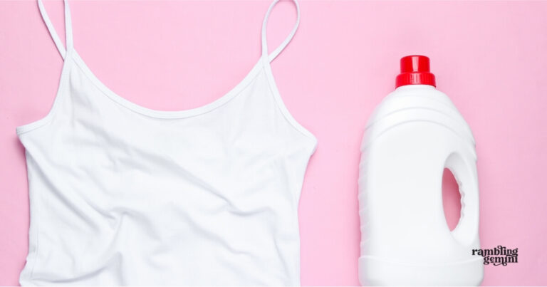 White camisole and laundry detergent bottle on pink background.