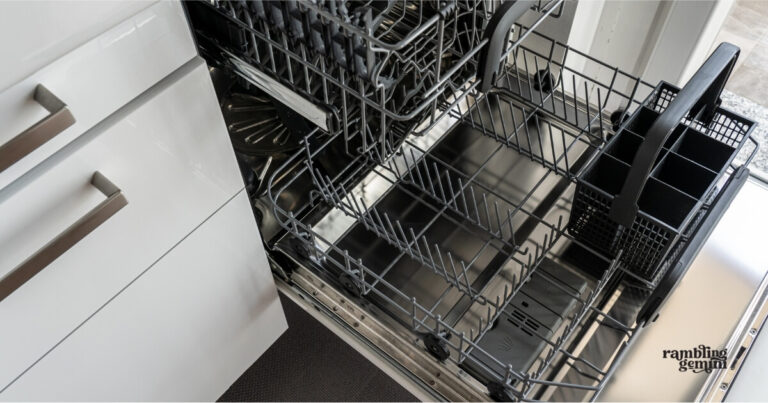 Modern kitchen dishwasher with stainless steel interior and organized racks.