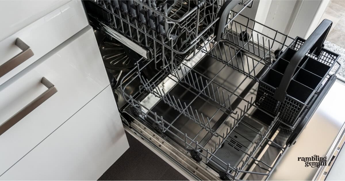 Modern kitchen dishwasher with stainless steel interior and organized racks.